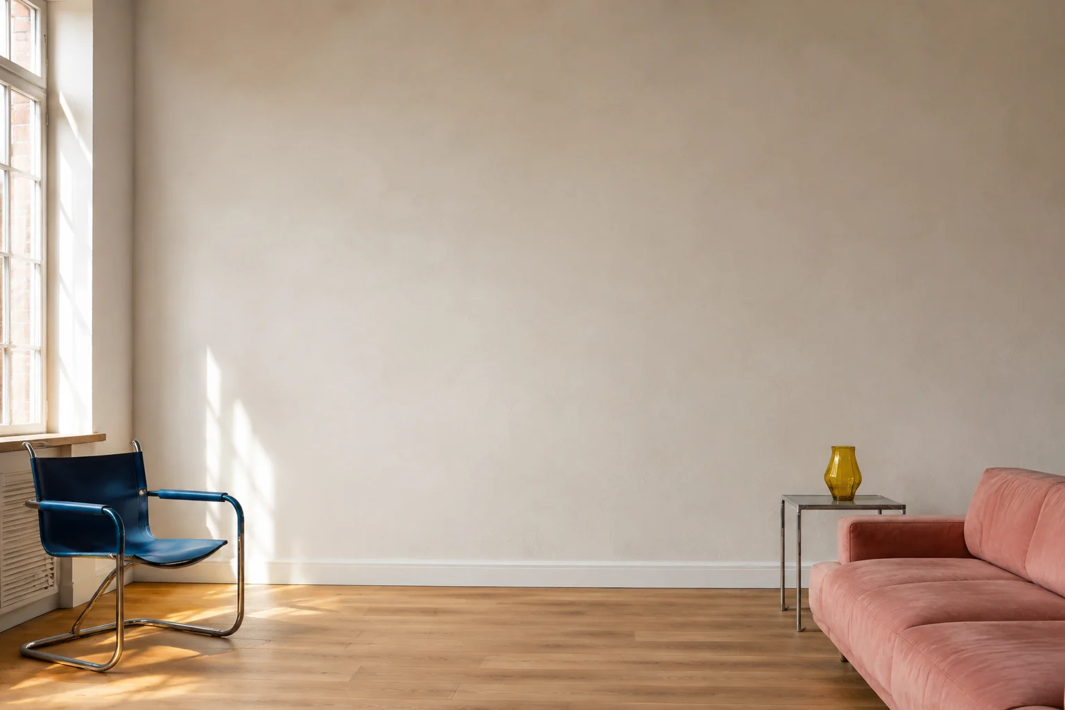 Sunlight in a living room with a blue chair and a pink sofa